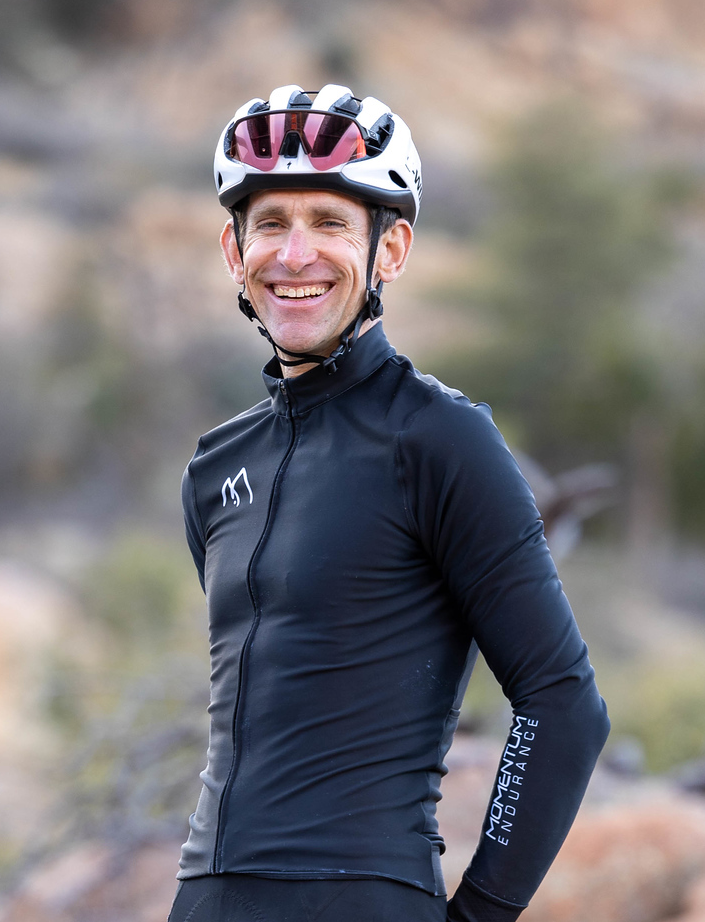 Coach Brian smiling wearing a helmet